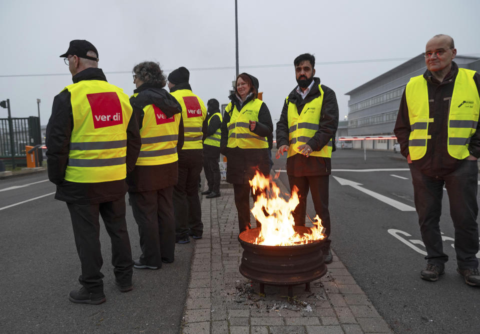 Employees of ViP (Verkehrsbetrieb Potsdam) demonstrate in front of the entrance to the depot in Potsdam, Germany, Friday March 1, 2024. Local buses, subway trains and trams ground to a halt in much of Germany Friday at the peak of a week of walkouts by employees demanding better working conditions. (Georg Moritz/dpa via AP)