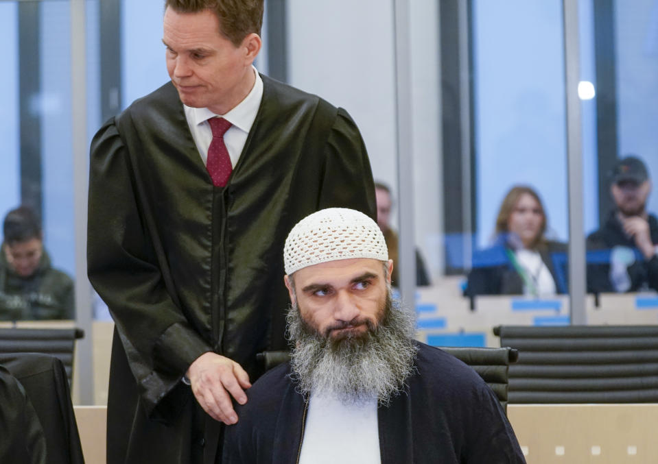 Zaniar Matapour with defense attorney Marius Dietrichson in Oslo courthouse Tuesday, March 12, 2024. The trial has begun in Norway for a man accused of aggravated terrorism for the deadly shooting at an LGBTQ+ festival in Oslo’s nightlife district. Two people were killed and nine seriously wounded in the shooting in June 2022. The prosecutor says the Norwegian citizen originally from Iran had sworn allegiance to the Islamic State group. (Lise Åserud/NTB Scanpix via AP)
