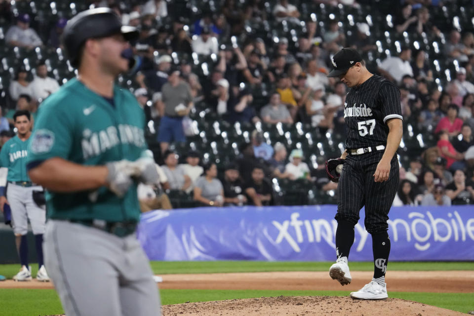 Chicago White Sox relief pitcher Tanner Banks, right, kicks the mound as Seattle Mariners' Ty France walks to first base after being hit by a pitch during the sixth inning of a baseball game in Chicago, Monday, Aug. 21, 2023. (AP Photo/Nam Y. Huh)