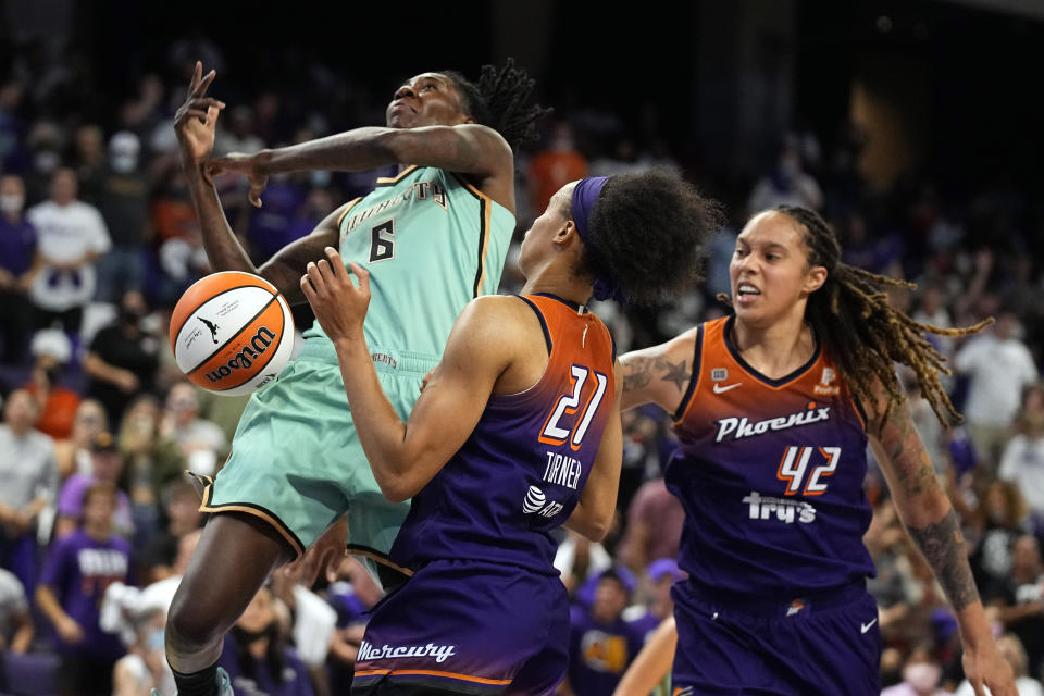 New York Liberty forward Natasha Howard (6) drives against Phoenix Mercury forward Brianna Turner (21) and Phoenix Mercury center Brittney Griner (42) during the second half in the first round of the WNBA basketball playoffs, Thursday, Sept. 23, 2021, in Phoenix. Phoenix won 83-82. (AP Photo/Rick Scuteri)