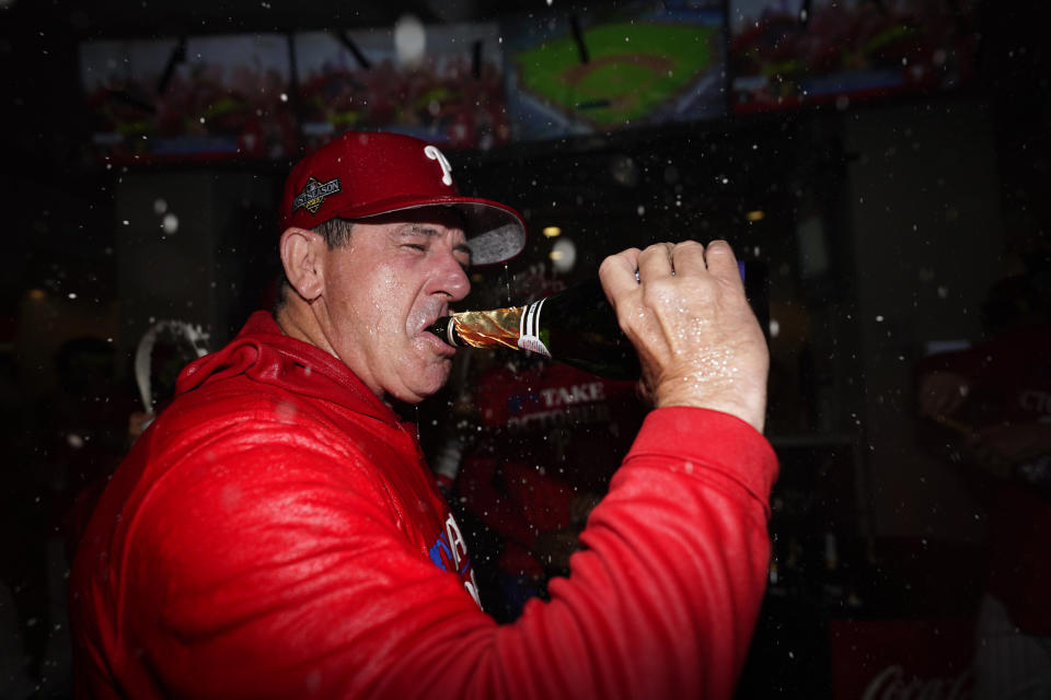 Philadelphia Phillies' Rob Thomson celebrates after winning a baseball game against the Pittsburgh Pirates to clinch a wild-card playoff spot, Tuesday, Sept. 26, 2023, in Philadelphia. (AP Photo/Matt Slocum)