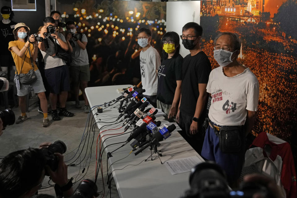 Chow Han Tung, vice chairwoman of the Hong Kong Alliance in Support of Patriotic Democratic Movements of China, second left, and other group members attend a news conference in Hong Kong, Sunday, Sept. 5, 2021. The group behind the annual Tiananmen Square memorial vigil in Hong Kong said Sunday it will not cooperate with police conducting a national security investigation into the group's activities, calling it an abuse of power. (AP Photo/Kin Cheung)