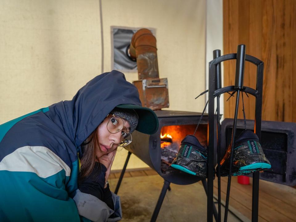 The author dries her sneakers in front of the fire.