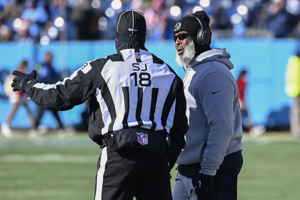 Houston Texans head coach Lovie Smith speaks with side judge Clay Reynard (18) during the first half of an NFL football game against the Tennessee Titans, Saturday, Dec. 24, 2022, in Nashville, Tenn. (AP Photo/Mark Zaleski)