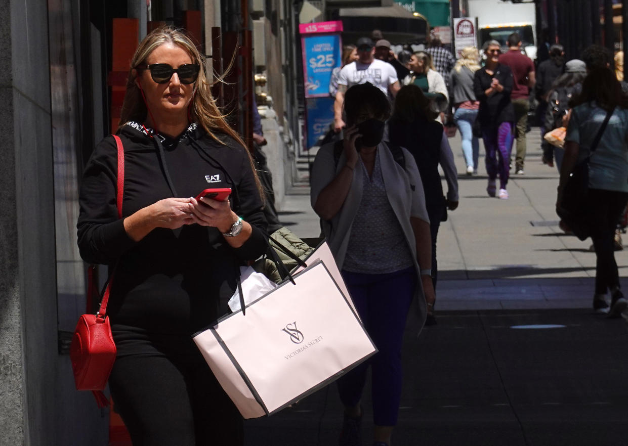 SAN FRANCISCO, CALIFORNIA - MAY 17: A pedestrian carries shopping bags while walking through Union Square on May 17, 2022 in San Francisco, California. Monthly retail sales were up 0.9 percent in April, just shy of the expected 1 percent increase as consumer spending increases. (Photo by Justin Sullivan/Getty Images)