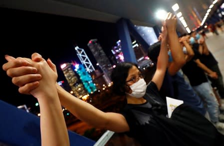 Protesters hold hands to form a human chain during a rally to call for political reforms in Hong Kong's Central district