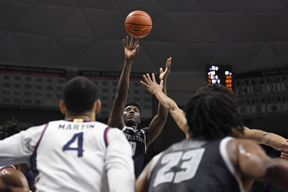 Georgetown's Aminu Mohammed, center, goes up to the basket in the first half of an NCAA college basketball game against Connecticut, Tuesday, Jan. 25, 2022, in Storrs, Conn. (AP Photo/Jessica Hill)