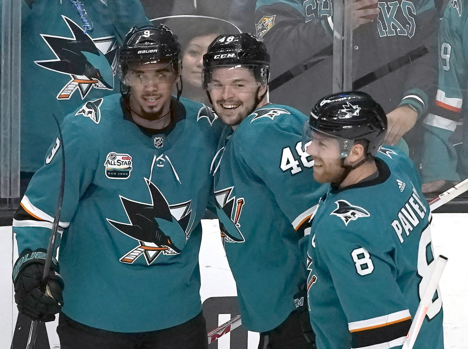 San Jose Sharks center Tomas Hertl (48) celebrates with Evander Kane (9) and Joe Pavelski (8) after his third goal against the Pittsburgh Penguins for a hat trick, during the third period in an NHL hockey game in San Jose, Calif., Tuesday, Jan. 15, 2019. San Jose won 5-2. (AP Photo/Tony Avelar)