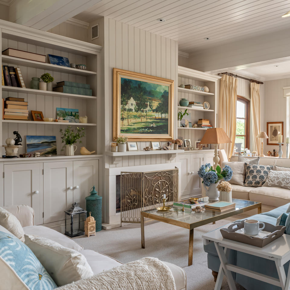 brightly painted living room with wood paneling on walls and ceiling as well as niche cupboards