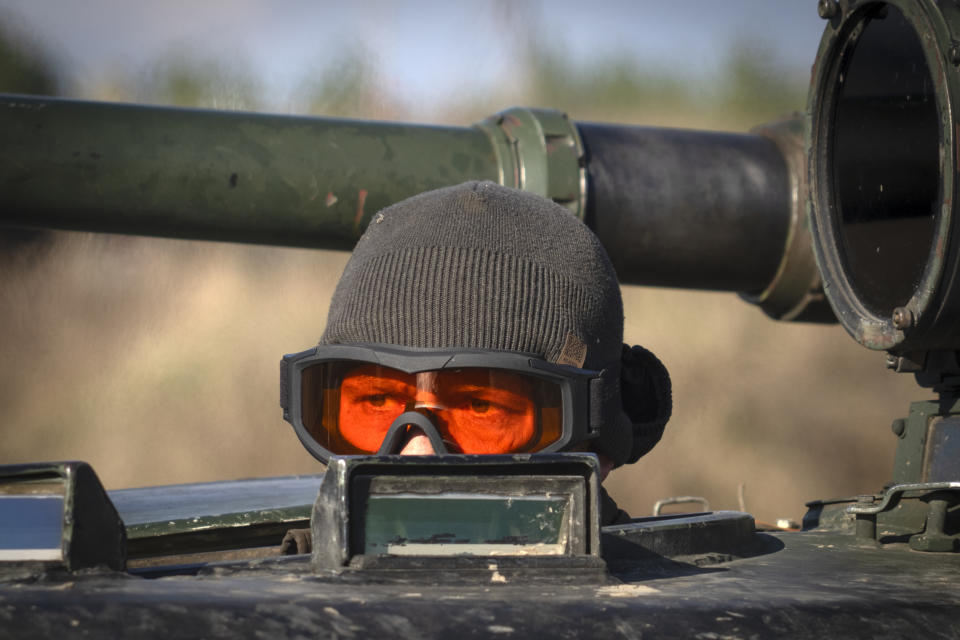 A soldier of Ukraine's National Guard 1st brigade Bureviy (Hurricane) looks out an APC during combat training at a military training ground in the north of Ukraine Friday, Nov. 3, 2023. (AP Photo/Efrem Lukatsky)