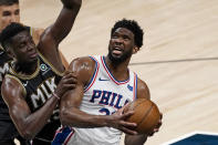 Philadelphia 76ers center Joel Embiid (21) is defended by Atlanta Hawks center Clint Capela (15) as he goes in for a basket during the first half of Game 6 of an NBA basketball Eastern Conference semifinal series Friday, June 18, 2021, in Atlanta. (AP Photo/John Bazemore)