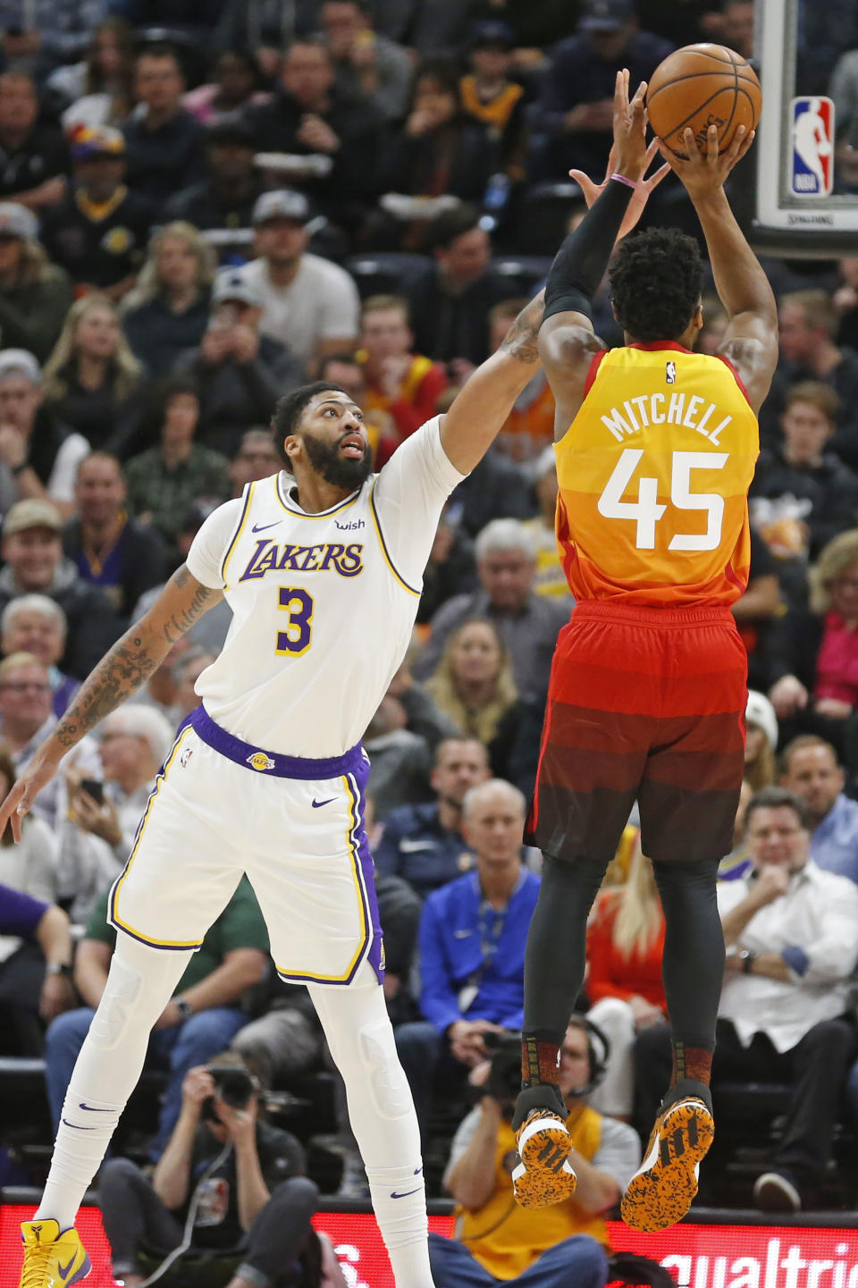 Utah Jazz guard Donovan Mitchell (45) shoots as Los Angeles Lakers forward Anthony Davis (3) defends in the first half during an NBA basketball game Wednesday, Dec. 4, 2019, in Salt Lake City. (AP Photo/Rick Bowmer)