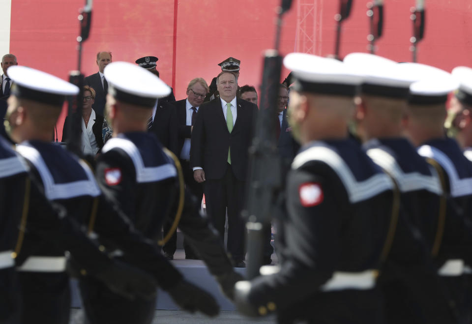 U.S. Secretary of State Mike Pompeo stands in respect for the Polish military as Poland marks the centennial of the Battle of Warsaw, a Polish military victory in 2020 that stopped the Russian Bolshevik march toward the west, in Warsaw, Poland, Saturday Aug. 15, 2020. Pompeo attended as he wrapped up a visit to central Europe..(AP Photo/Czarek Sokolowski)