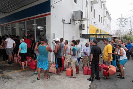 People line up to buy gasoline in San Juan. REUTERS/Alvin Baez