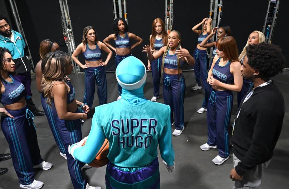 Super Hugo meets with the Honey Bees prior to halftime of the team’s game against the Phoenix Suns. The halftime show would be Super Hugo and the Flight Squad dunking while the Honey Bees danced. The Hornets hosted the Suns at Spectrum Center in Charlotte, NC on Friday, March 15, 2024. JEFF SINER/jsiner@charlotteobserver.com