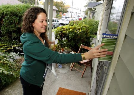 Canvasser Jenny Smith leaves campaign flyer to drum up support for Oregon's Measure 91, which would legalize the recreational use of marijuana in Portland, Oregon October 28, 2014. REUTERS/Steve Dipaola