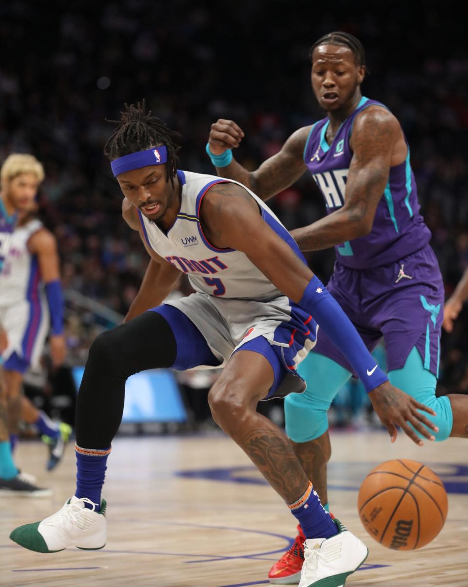 Detroit Pistons forward Jerami Grant (9) is defended by Charlotte Hornets guard Terry Rozier (3) Friday, Feb. 11, 2022 at Little Caesars Arena.