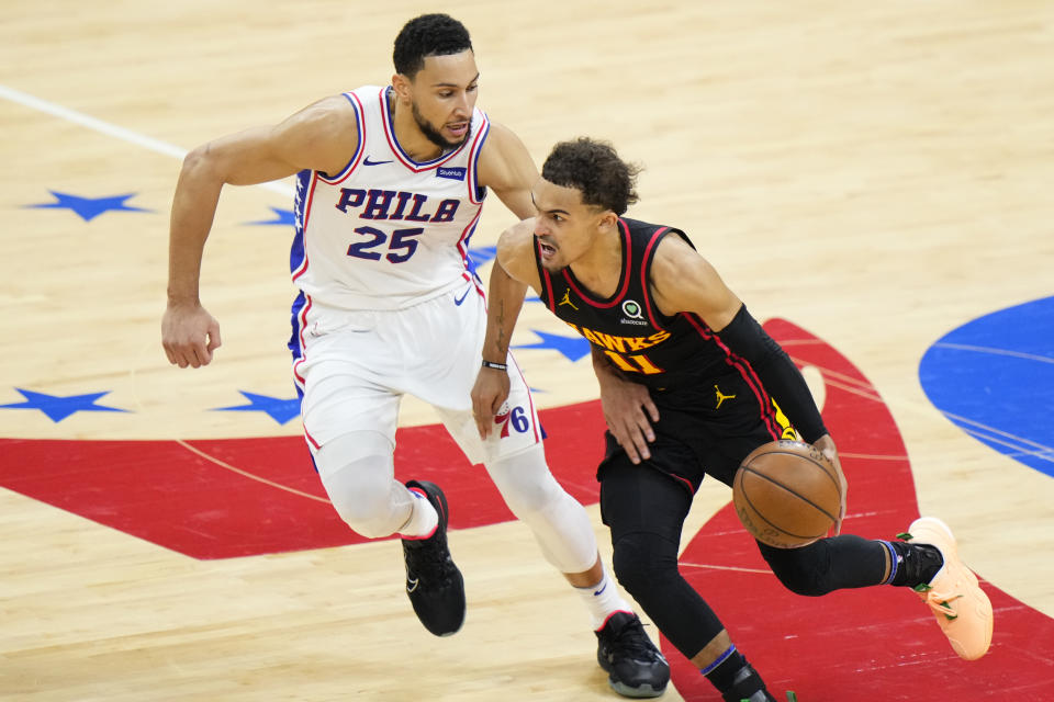 Atlanta Hawks' Trae Young, right, tries to get past Philadelphia 76ers' Ben Simmons during the second half of Game 7 in a second-round NBA basketball playoff series, Sunday, June 20, 2021, in Philadelphia. (AP Photo/Matt Slocum)