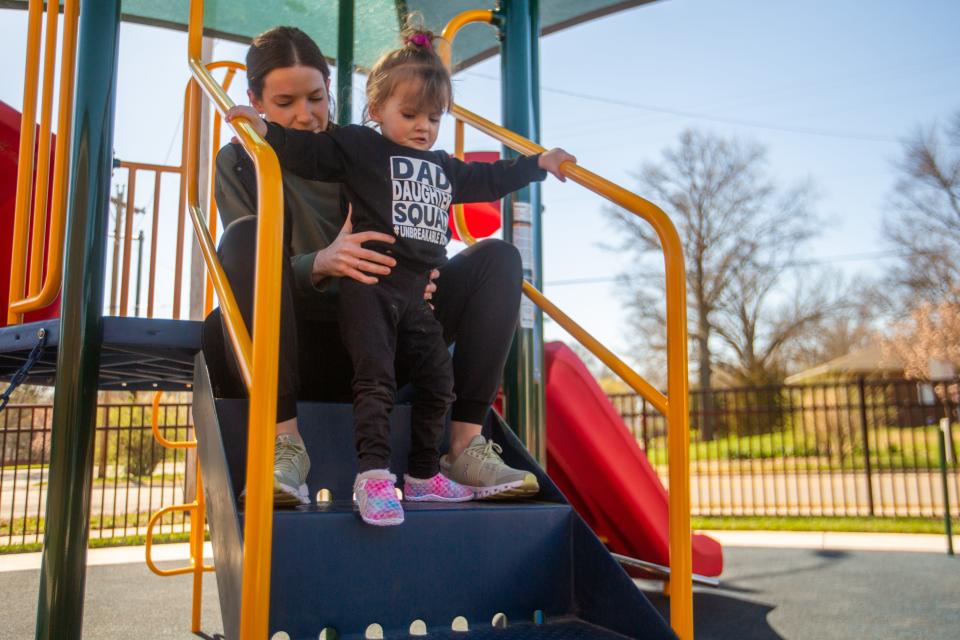 Amira Payne works on gross motor skills with physical therapist Marie Young at Quinton Heights Education Center's playground since her home playground at Williams Science and Fine Arts Magnet Elementary School isn't as accessible.