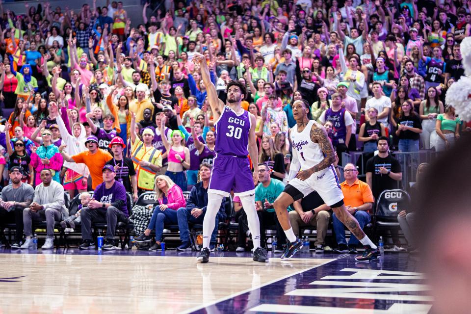 Grand Canyon's Gabe McGlothan (30) watches his shot from the corner alongside New Mexico State's James Beck on Wednesday at GCU Arena