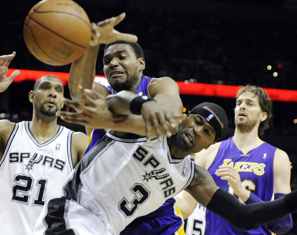 Los Angeles Lakers center Andrew Bynum, top center, and San Antonio Spurs forward Stephen Jackson fight for a loose ball as Spurs forward Tim Duncan, left, and Lakers forward Pau Gasol, right, of Spain, close in during the first half of an NBA basketball game on Friday, April 20, 2012, in San Antonio. (AP Photo/Bahram Mark Sobhani)