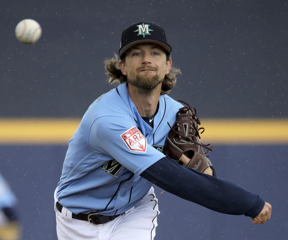 Seattle Mariners starting pitcher Mike Leake throws during the first inning of a spring training baseball game against the Oakland Athletics, Friday, Feb. 22, 2019, in Peoria, Ariz. (AP Photo/Charlie Riedel)