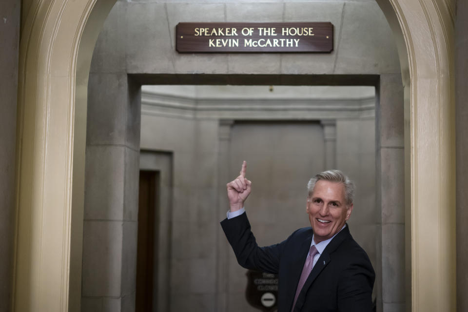 FILE - House Speaker Kevin McCarthy of Calif., gestures towards the newly installed nameplate at his office after he was sworn in as speaker of the 118th Congress in Washington, early Saturday, Jan. 7, 2023. (AP Photo/ Matt Rourke, File)
