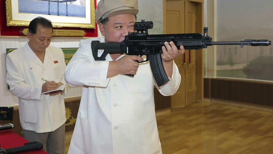 In this undated photo provided by the North Korean government, North Korean leader Kim Jong Un, right, holds a weapon during his three-day inspection from Aug. 3 until Aug. 5, 2023 at major munitions factories in North Korea. Independent journalists were not given access to cover the event depicted in this image distributed by the North Korean government. The content of this image is as provided and cannot be independently verified. (Korean Central News Agency/Korea News Service via AP)