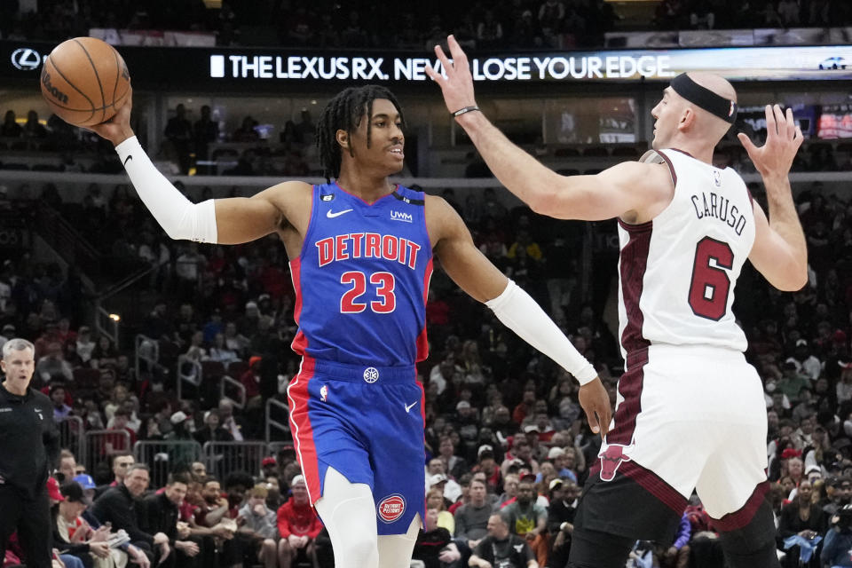 Detroit Pistons guard Jaden Ivey, left, looks to pass as Chicago Bulls guard Alex Caruso guards during the first half of an NBA basketball game in Chicago, Sunday, April 9, 2023. (AP Photo/Nam Y. Huh)