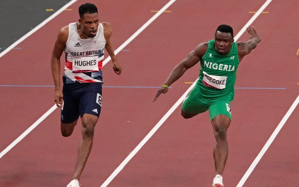 Zharnel Hughes, of Britain, left, won his men's 100m semi final, beating Enoch Adegoke of Nigeria - AP Photo/Charlie Riedel