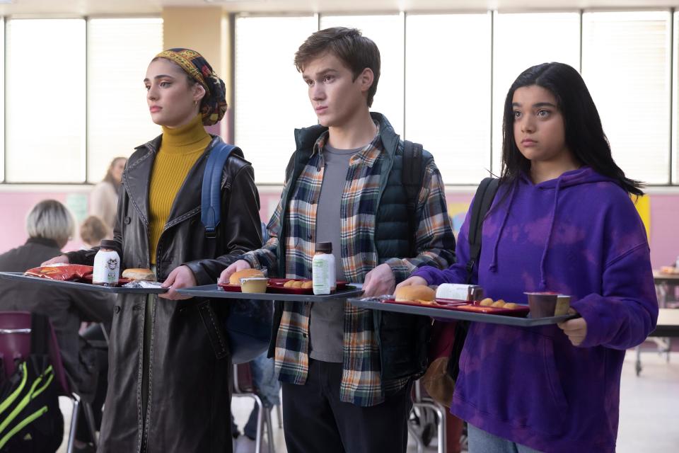 Kamala (right, Iman Vellani) hits the school cafeteria with friends Nakia (Yasmeen Fletcher) and Bruno (Matthew Lintz) in the Disney+ series "Ms. Marvel."