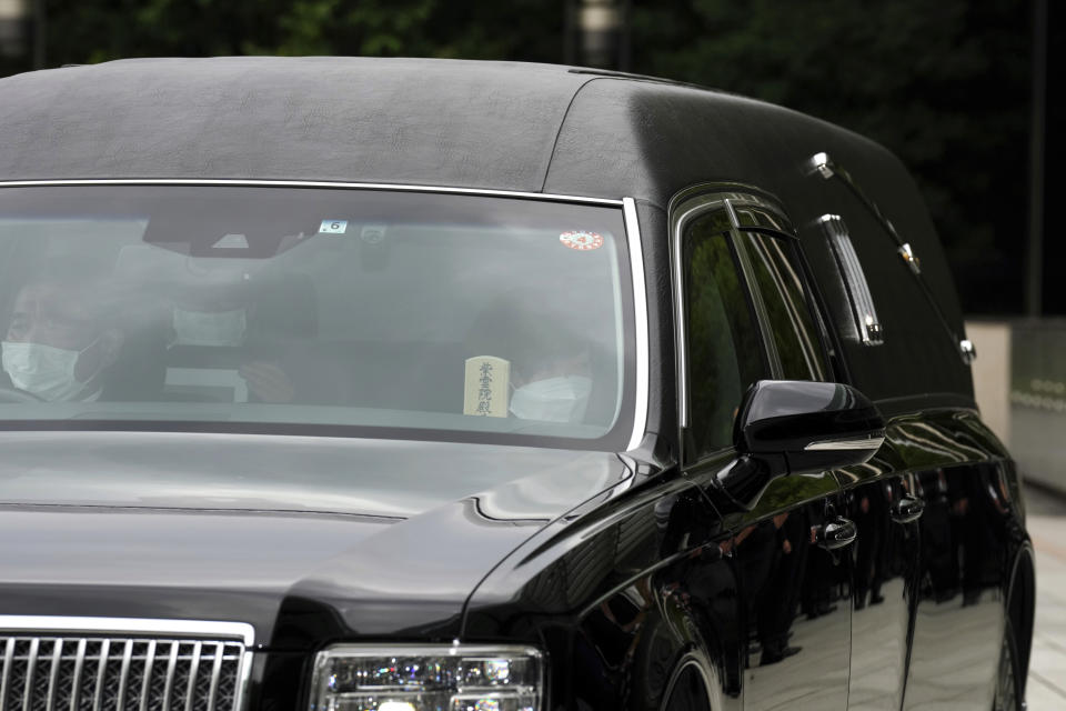 Akie Abe, wife of Japan's former Prime Minister Shinzo Abe, sitting in a hearse as the vehicle carrying the body of former Prime Minister Shinzo Abe, makes a brief visit to the Prime Minister's Office Tuesday, July 12, 2022, in Tokyo. (AP Photo/Eugene Hoshiko, Pool)
