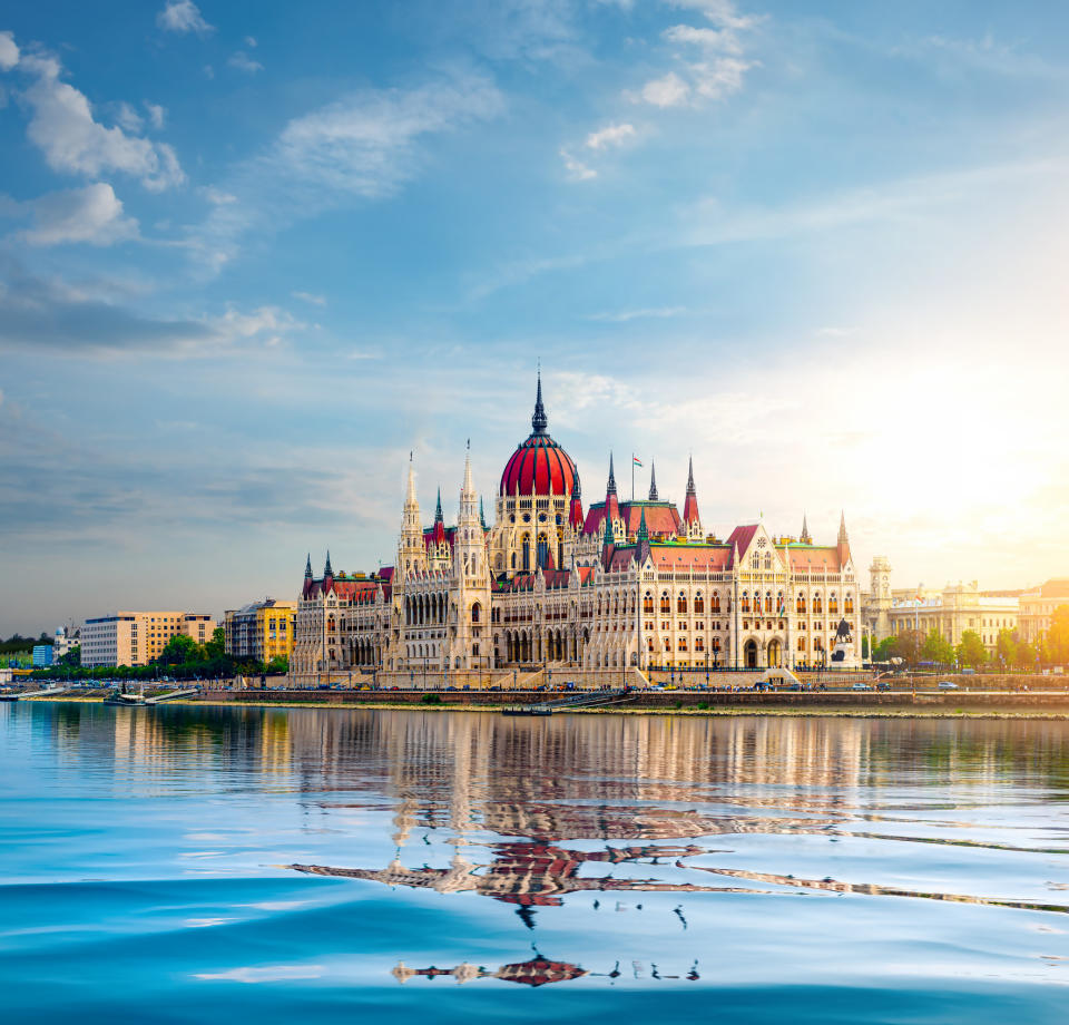 Sun over Parliament in Budapest at sunset.