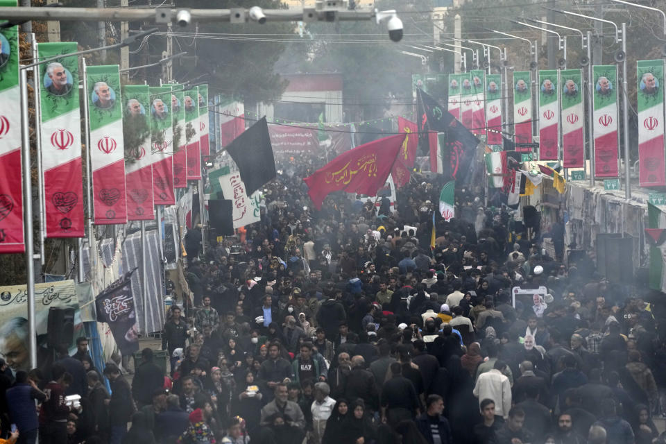 People walk on the street towards the grave of the late Iranian Revolutionary Guard Gen. Qassem Soleimani in the city of Kerman about 510 miles (820 kms) southeast of the capital Tehran, Iran, Thursday, Jan. 4, 2024. Investigators believe suicide bombers likely carried out an attack on a commemoration for an Iranian general slain in a 2020 U.S. drone strike, state media reported Thursday, as Iran grappled with its worst mass-casualty attack in decades and as the wider Mideast remains on edge. (AP Photo/Vahid Salemi)