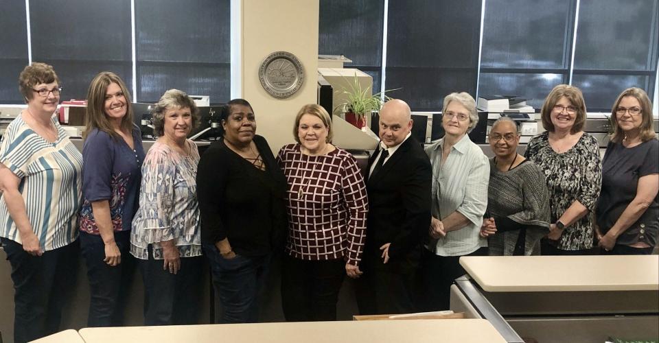 Retiring Shawnee County Clerk Cyndi Beck, center, poses with clerk's office employees, from left, Kristine Otto, Tricia Kirkwood, Lori Rea, Stephanie Shaw, John Morgan, Deborah Brock, Andrea Arrington, Lucy Tindell and Lisa Crowder. Absent is Rhonda Praiswater.