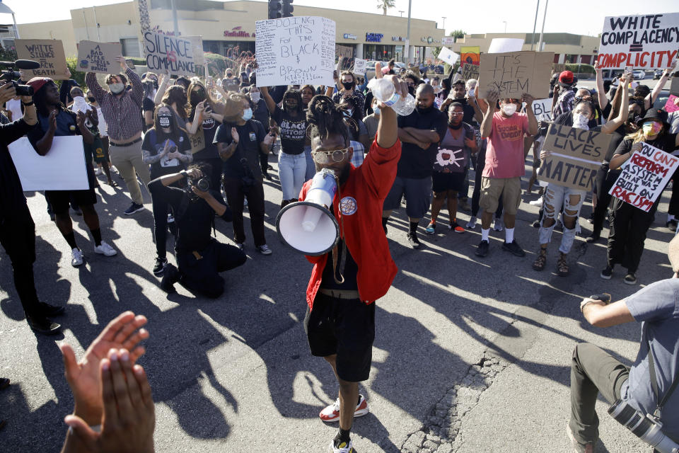 Protesters gather at an intersection during a demonstration to commemorate Juneteenth Friday, June 19, 2020, in Lancaster, Calif. Juneteenth is the holiday celebrating the day in 1865 that enslaved Black people in Galveston, Texas, learned they had been freed from bondage, more than two years after the Emancipation Proclamation. (AP Photo/Marcio Jose Sanchez)