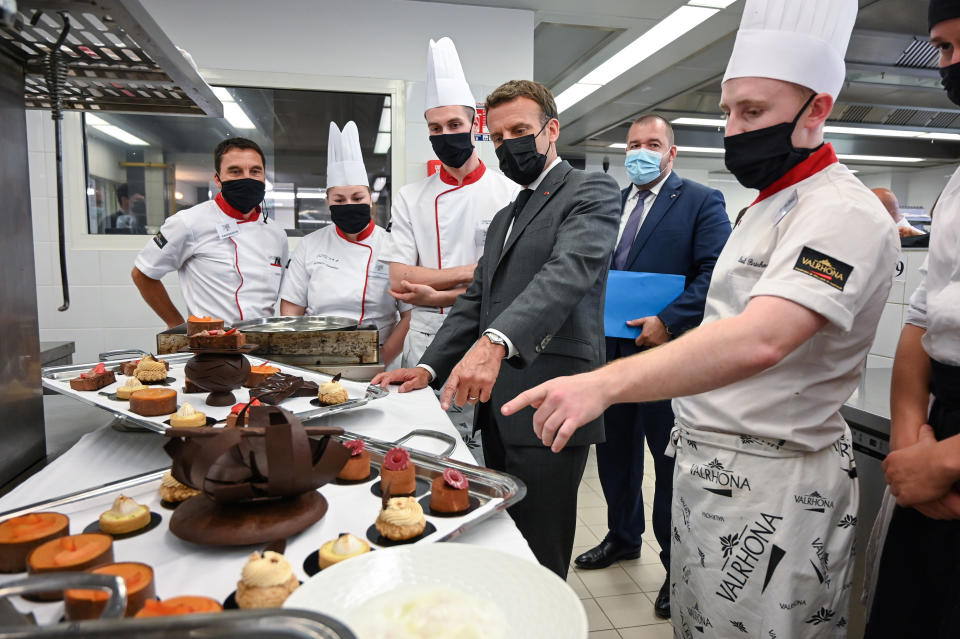 French President Emmanuel Macron talks with cooking students , Tuesday June 8, 2021 in the kitchen of the Hospitality school in Tain-l'Hermitage, southeastern France. (Philippe Desmazes, Pool via AP)