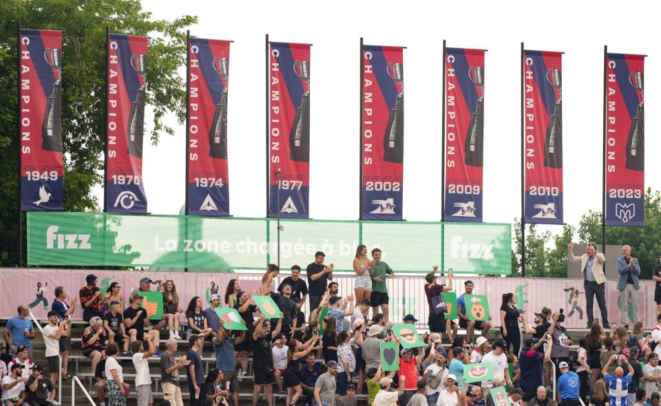 Montreal Alouettes owner Pierre Karl Peladeau, second from right, gestures as they unveil their CFL Grey Cup championship football banner prior to their game against the Ottawa Redblacks in Montreal, Thursday, June 20, 2024.  