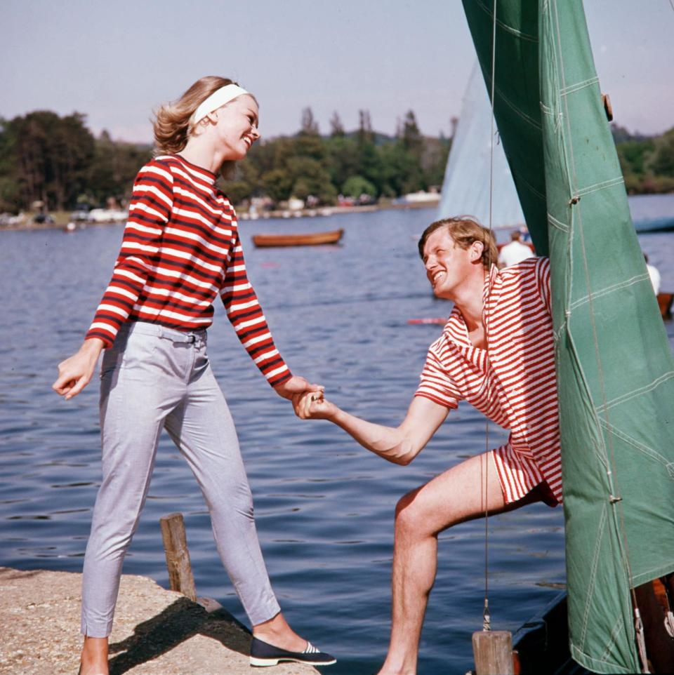 Two models wearing examples of holiday clothes are pictured about to go sailing