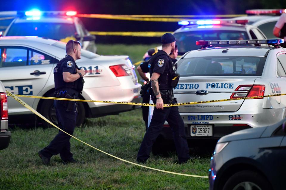 Louisville Metro Police gather at the scene of a shooting at the baseball fields in Shawnee Park, Sunday, July 10 2022 in Louisville Ky.