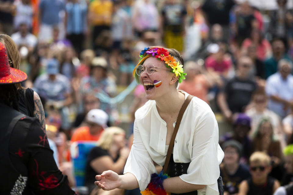 A Grand Haven Pride Fest attendee is seen cheering during a drag show at the Lynne Sherwood Waterfront Stadium in Grand Haven, Mich., on Saturday, June 10, 2023. The festival — which organizers had hoped would attract at least 500 attendees — drew thousands of people from all over who came to experience the first-time event's drag show, dance party and vendor-filled streets. (AP Photo/Kristen Norman)