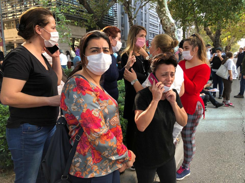 People stand outside their homes in Izmir, Turkey, Oct. 30, 2020, after a strong earthquake in the Aegean Sea has shaken Turkey and Greece.