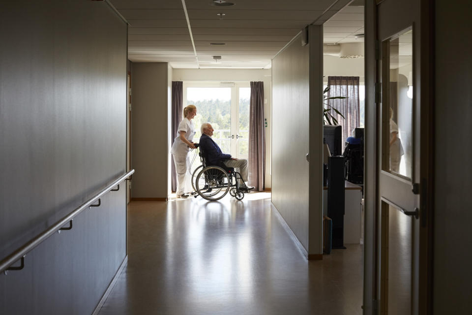 a nurse pushing a man in a wheelchair