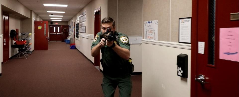 Okaloosa County School Resource Officer Deputy Tim Siren goes through a training exercise at a local school.