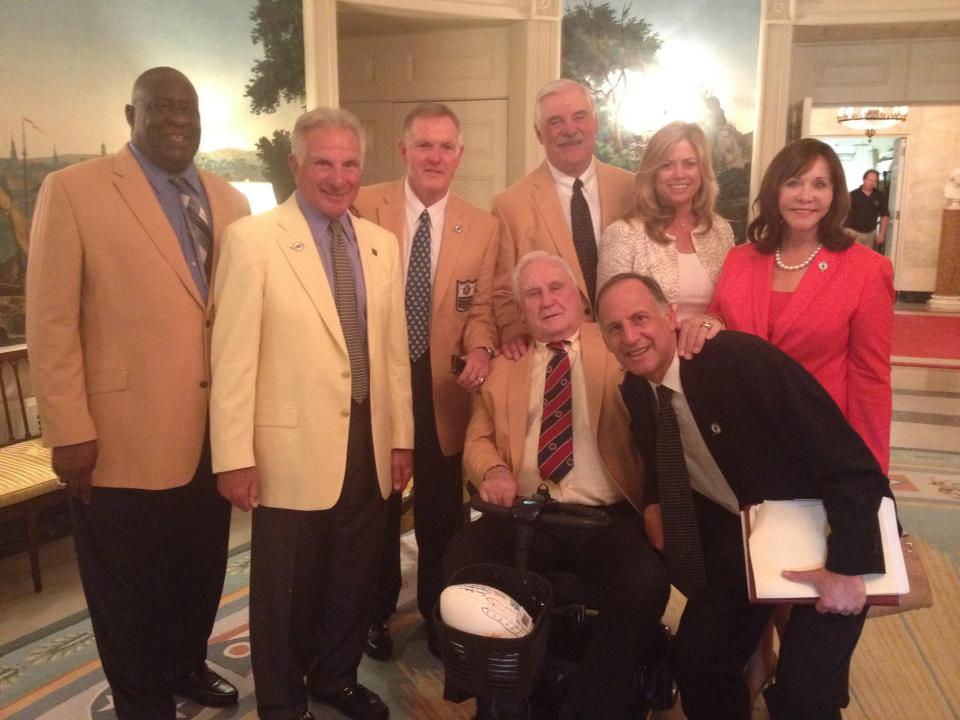 The traveling contingent of the 1972 Super Bowl-winning Miami Dolphins pauses in the Diplomatic Reception Room of the White House in 2013. The invitation came after the Obama Administration learned that the 17-0 team never made a White House trip. Here, Harvey Greene (front, row) poses with coach Don Shula. In the back row, from left, are Hall of Famers Larry Little, Nick Buoniconti, Bob Griese and Larry Csonka. With them are Csonka's wife, Audrey Bradshaw (next to Csonka), and Shula's wife, Mary Anne.