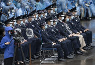 Hong Kong senior police officers including Commissioner of Police, Tang Ping-keung, front row fourth from left, attend a ceremony of the National Security Education Day at a police school in Hong Kong Thursday, April 15, 2021. Authorities marked the event with a police college open house, where police personnel demonstrated the Chinese military’s goose step march, replacing British-style foot drills from the time Hong Kong was ruled by the U.K. until the 1997 handover to China. (AP Photo/Vincent Yu)