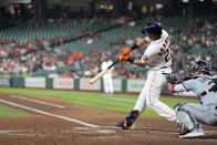 Houston Astros' Michael Brantley (23) hits a three-run home run as Chicago White Sox catcher Yasmani Grandal reaches for the pitch during the first inning of a baseball game Thursday, June 17, 2021, in Houston. (AP Photo/David J. Phillip)