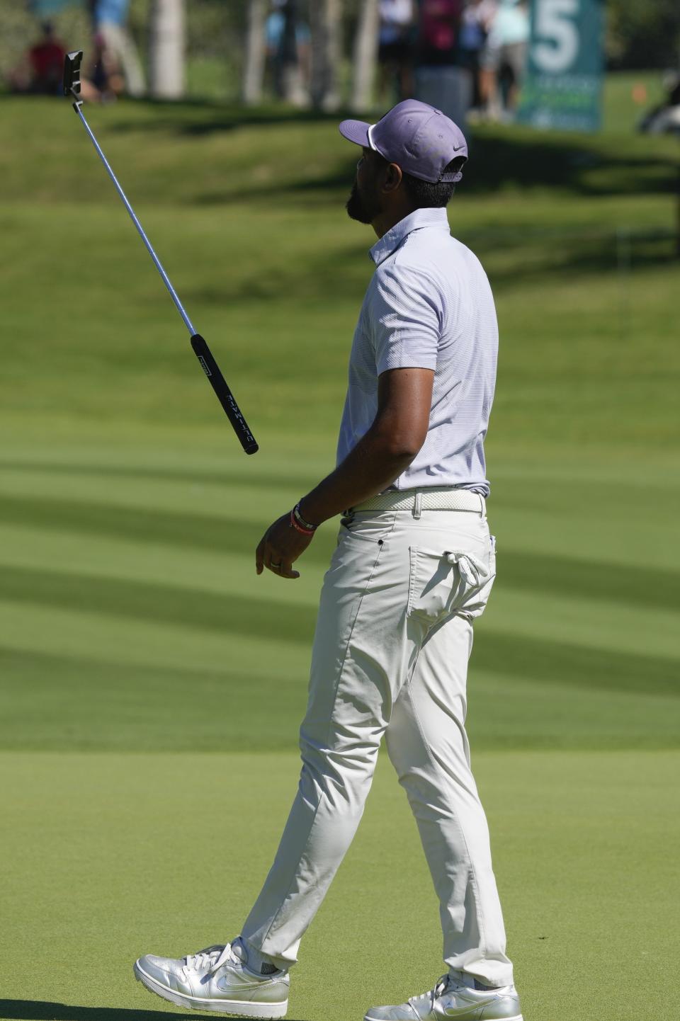 Tony Finau, of the United States, reacts to his putt on the fourth hole during the first round of the Mexico Open golf tournament in Puerto Vallarta, Mexico, Thursday, Feb. 22, 2024. (AP Photo/Fernando Llano)