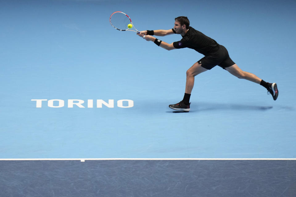 Britain's Cameron Norrie returns the ball to Norways' Casper Ruud during their ATP World Tour Finals singles tennis match, at the Pala Alpitour in Turin, Wednesday, Nov. 17, 2021. (AP Photo/Luca Bruno)
