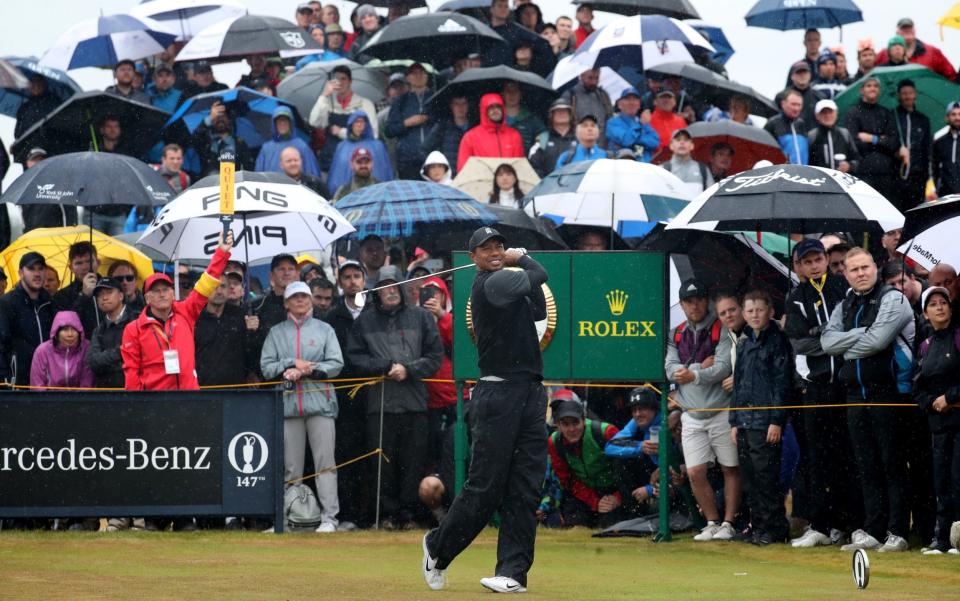 The rain did not deter the hoards of fans that followed Tiger Woods throughout his second round  - PA